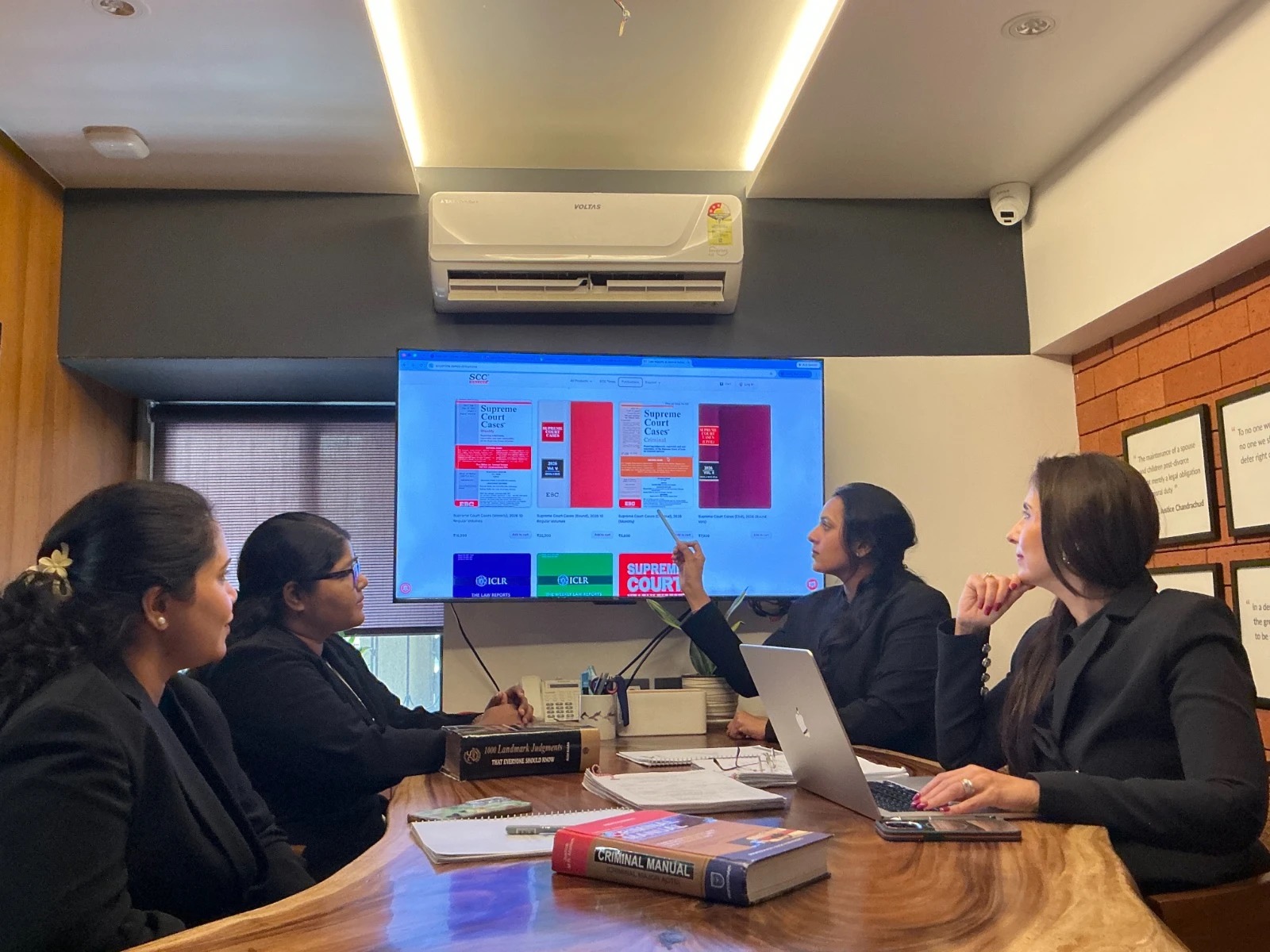 Eagle Law & Integrity advocates reviewing Supreme Court case reports on a screen in the firm's Mumbai conference room