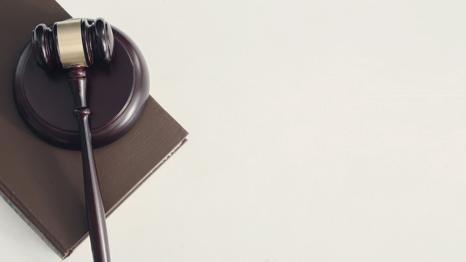 A gavel resting on a law book